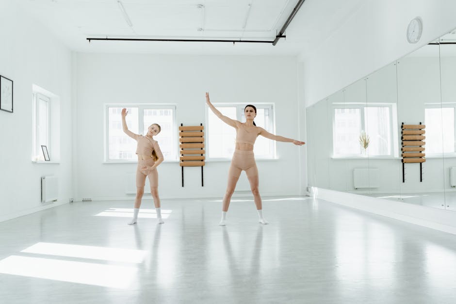Two women practicing ballet indoors with grace and elegance.